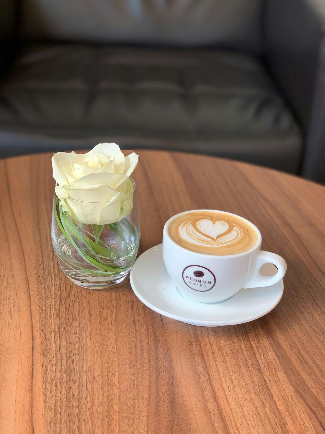 Cappuccino & white rose in a cup